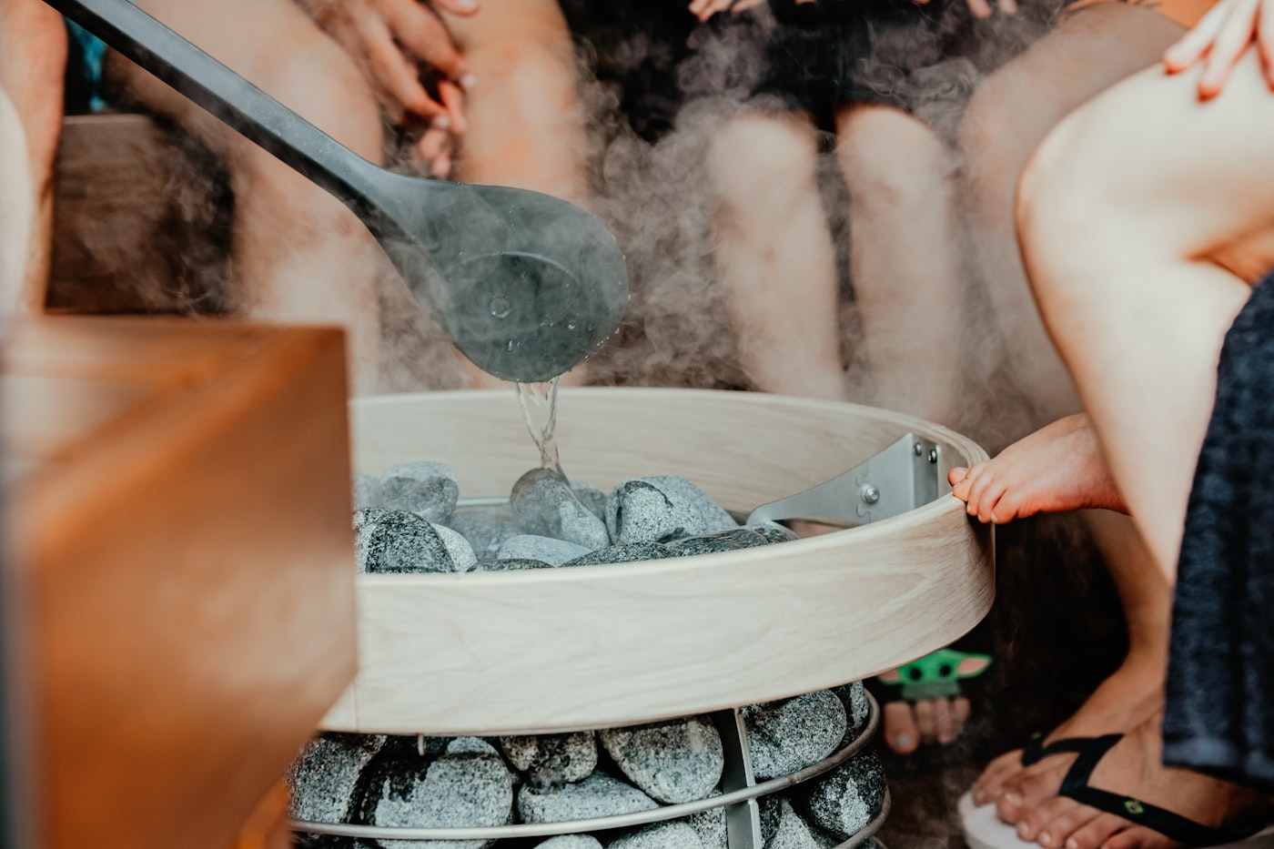 Steam rising from hot sauna stones